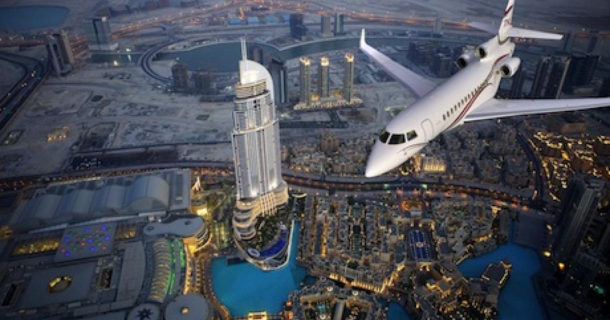 A Dassault Falcon 7X flies over the Burj Al Arab Hotel in Dubai.