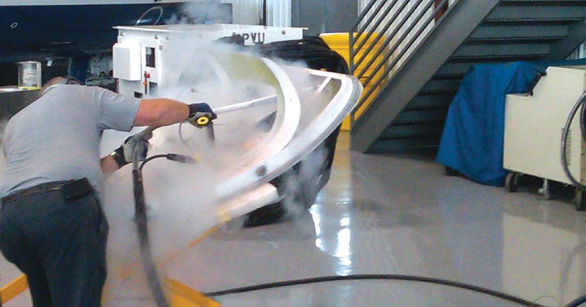 A Duncan Aviation maintenance tech uses the Aero 40 dry-ice blasting machine to remove the epoxy ramp from a Challenger passenger door.