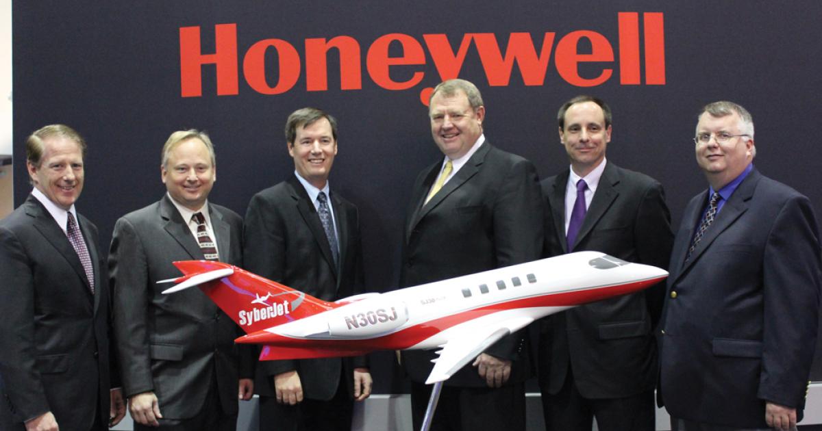 L to r: Chuck Taylor, SyberJet v-p; Ken Snodgrass, Honeywell v-p for integrated platform systems; John Todd, Honeywell v-p for Bombardier and Apex; David Grant, SyberJet president; Mark Fairchild, SyberJet general manager; and Rich Reisberg, SyberJet director of engineering were on hand for the announcement of the planned production restart of the SJ30 twinjet.