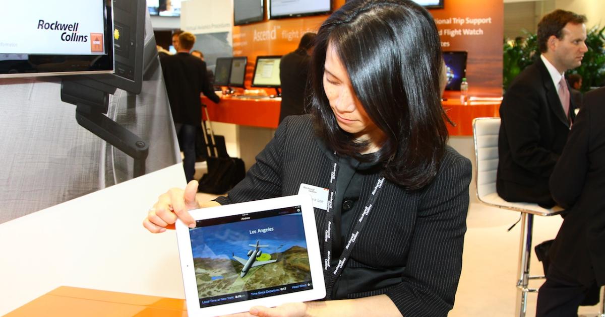 Sylvia Lee demonstrates the Rockwell Collins Airshow 3-D moving map for viewing on an iPad. Photo by David McIntosh