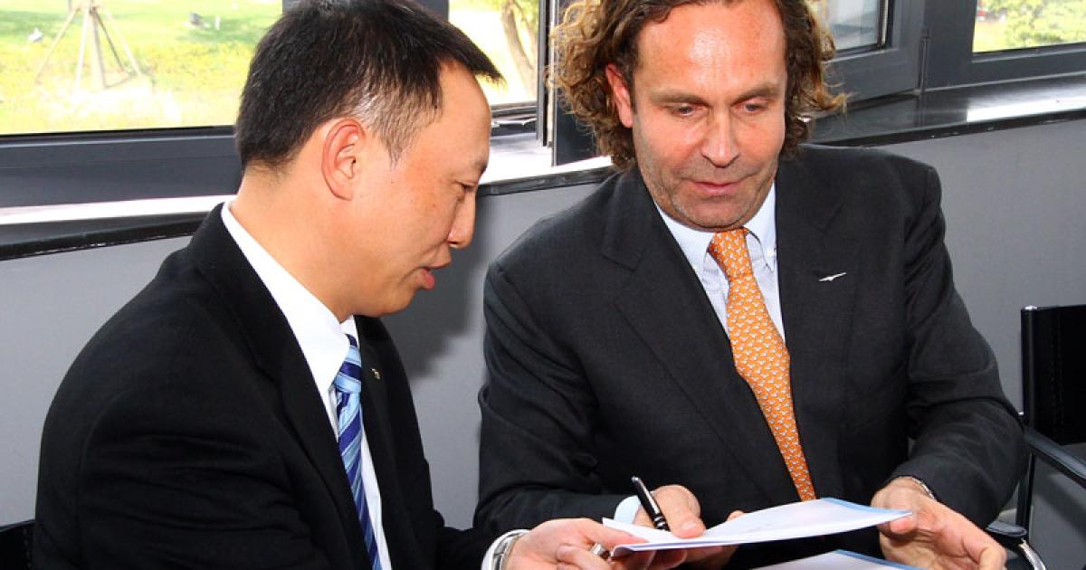 Weng Wei, vice president of Beijing Airlines, and Thomas Flohr, founder and chairman of VistaJet, signed  an a memorandum of understanding at ABACE yesterday for the establishment of a VistaJet base in Beijing. (Photo: David McIntosh)