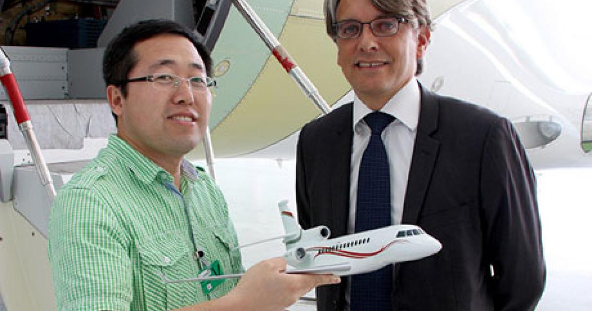 Wu Jian Ming, left (pictured with Eloi Dufour, Dassault Falcon director of customer relations and field service for the Eastern Hemisphere), recently became the 300th student to complete Dassault Falcon’s certified practical training program.