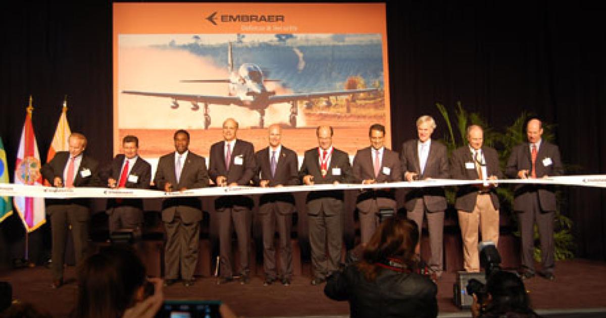 Florida Gov. Rick Scott and Embraer CEO Frederico Curado, at center, were joined by other politicians and executives at the March 26 ribbon-cutting ceremony in Jacksonville, Fla. (Photo: Embraer) 