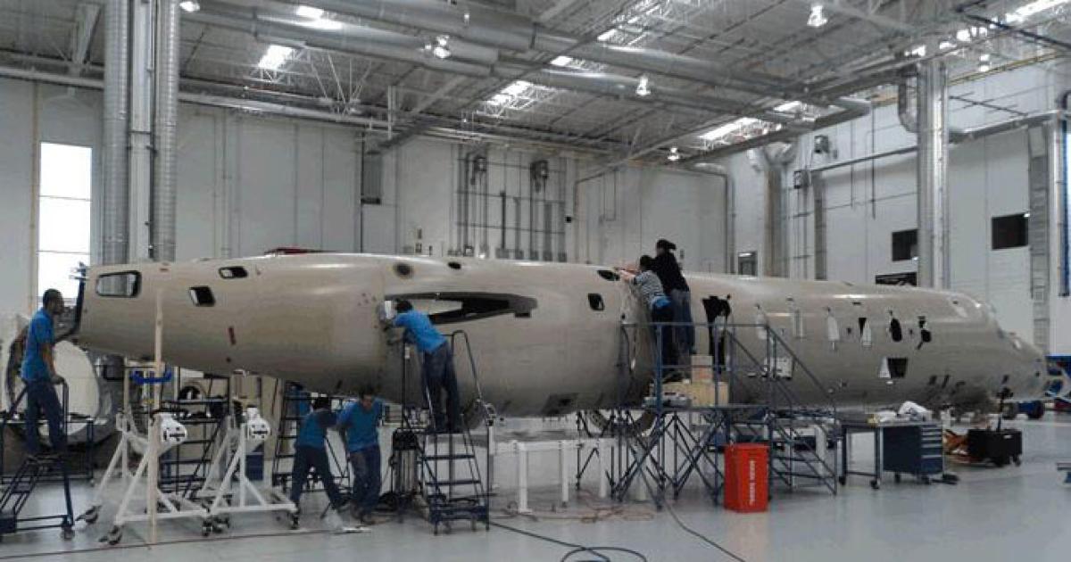 A full-length composite fuselage has been assembled, and production of the first flight-test airplane is under way.