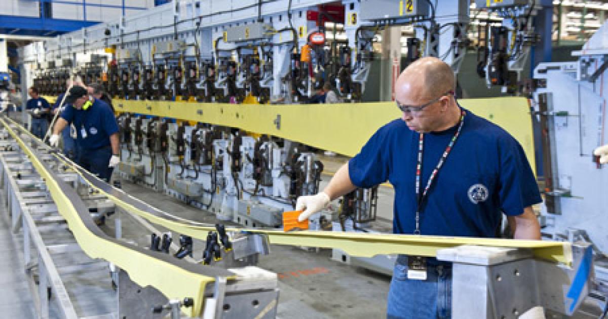 Boeing mechanic Larry Freeman prepares a part for loading into the automated spar assembly tool at the 737 factory in Renton, Washington. (Photo: Boeing)