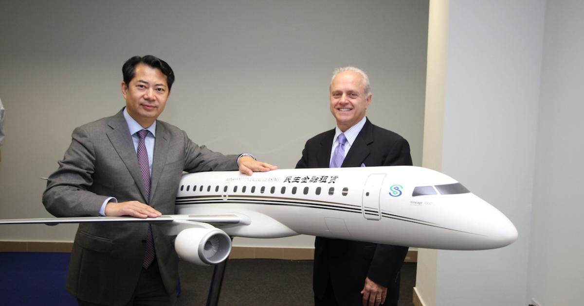 Guan Dongyuan, president, Embraer China, and Ernie Edwards, president, Embraer Executive Jets celebrate Minsheng Financial Leasing's order for three Lineage 1000 jets. Photo by David McIntosh.