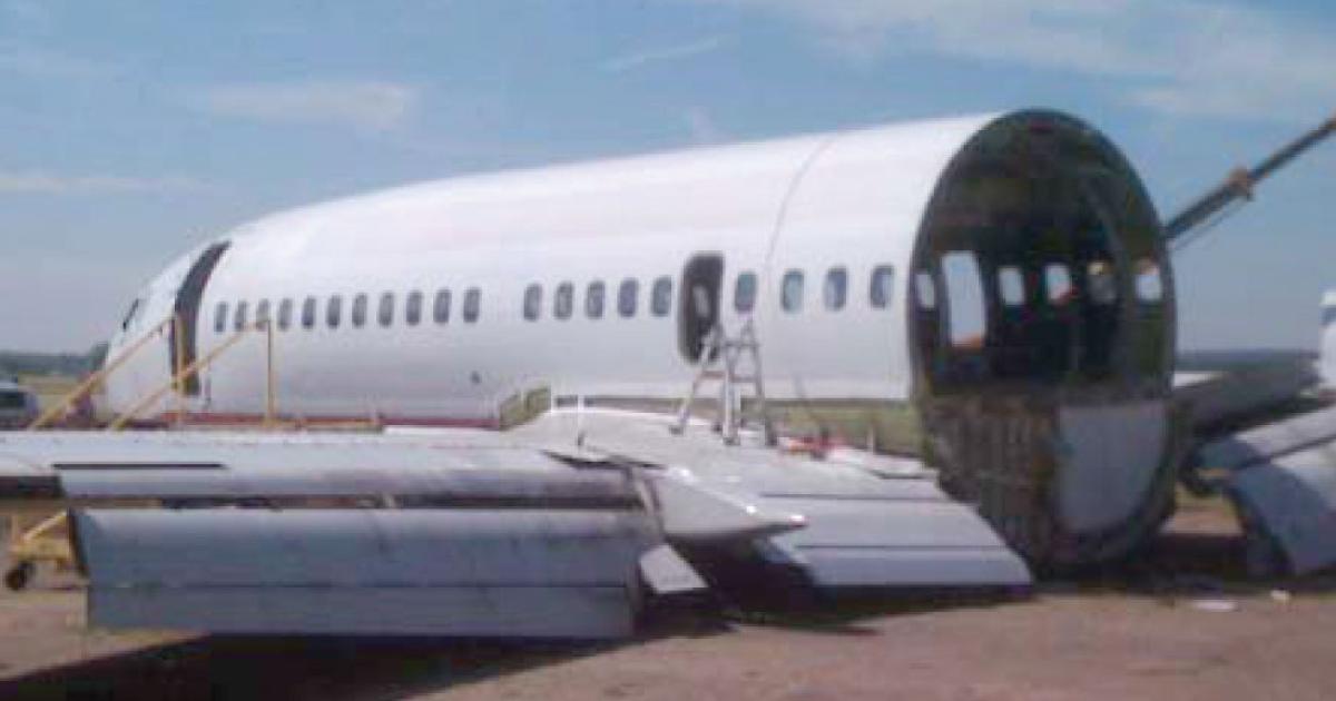 A retired 737-300 fuselage is prepared for a new life as a BBJ interior completions mockup at StandardAero’s Associated Air Center facility in Dallas.