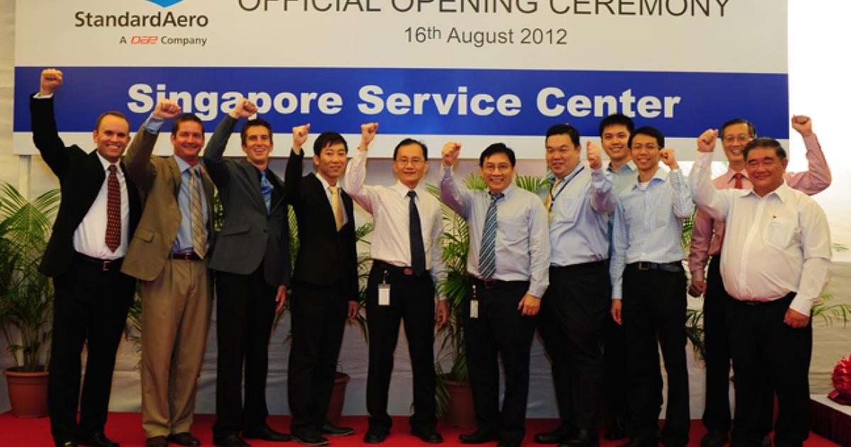 StandardAero employees and Singaporean authorities celebrate the opening of the company's helicopter facility at Seletar Aerospace Park.