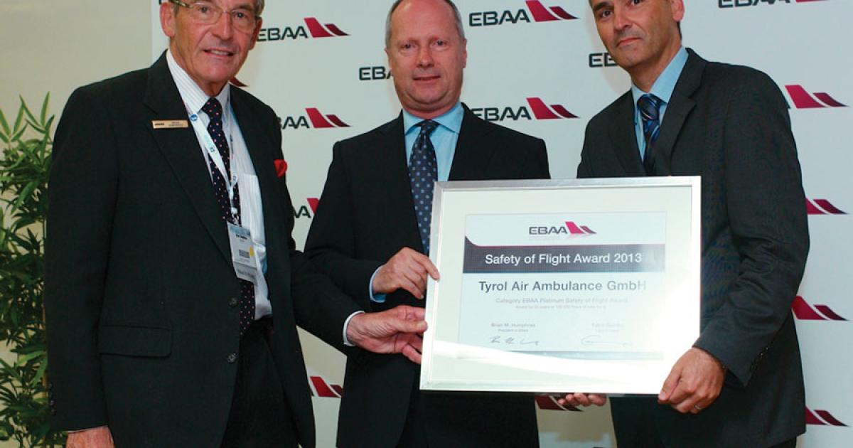 EBAA president Brian Humphries, left, presents a Platinum Safety of Flight Award to Tyrol Air Ambulance.