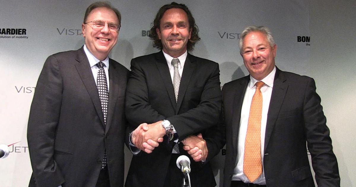 Linking arms over the pact are, left to right, Bombardier Business Aircraft president Steve Ridolfi, VistaJet founder Thomas Flohr and Bombardier v-p of sales Bob Horner.