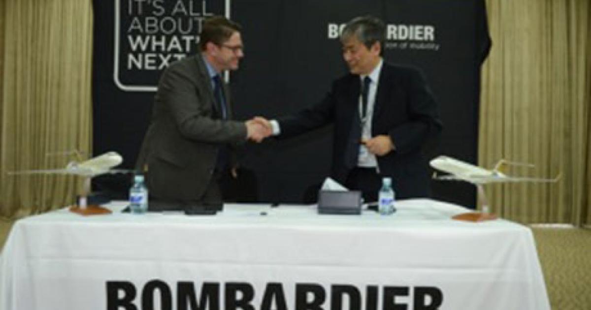 Éric Martel, president of Bombardier customer services, and Zhang Xueheng, Beijing Airlines vice president and general manager, sign a service agreement for Beijing Airlines to provide technical support to all Bombardier business aircraft based in and landing at Beijing Capital International Airport.