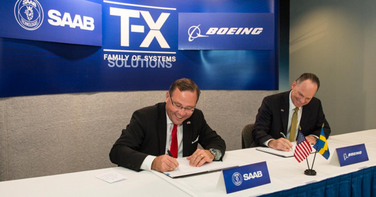 Saab president and CEO Håkan Buskhe, left, and Boeing Military Aircraft president Chris Chadwick sign joint development agreement on December 5 in St. Louis. (Photo: Boeing)  