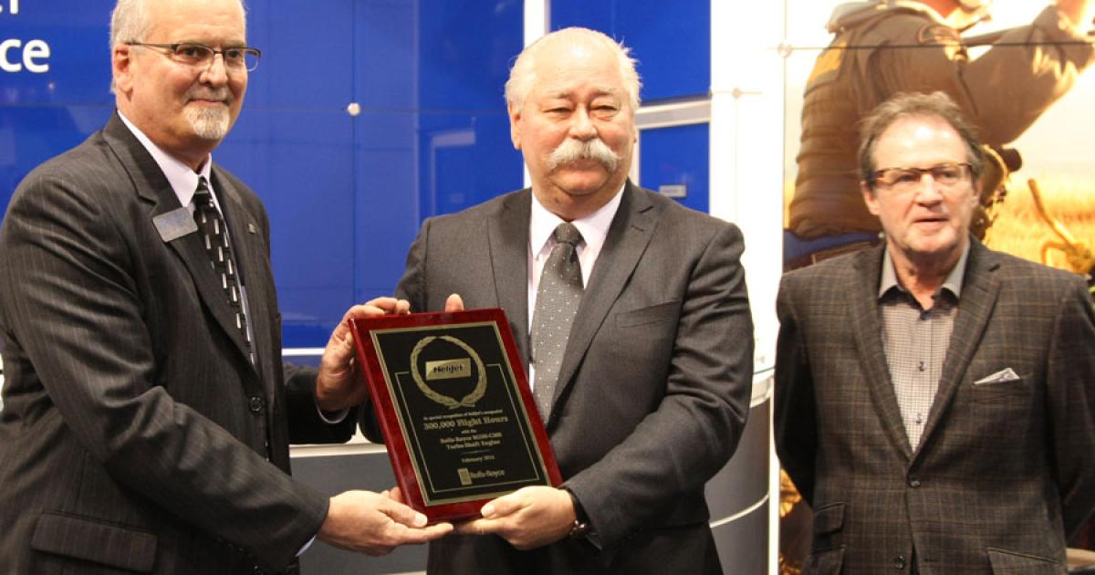 At Heli-Expo, Tim McGrath (left), Rolls-Royce v-p of customer business, honored Alistair MacLennan, Helijet chairman (center), and Brian Walker, Helijet director, on achieving 300,000 engine flight hours with their Sikorsky S-76A fleet. (Photo: Mariano Rosales)