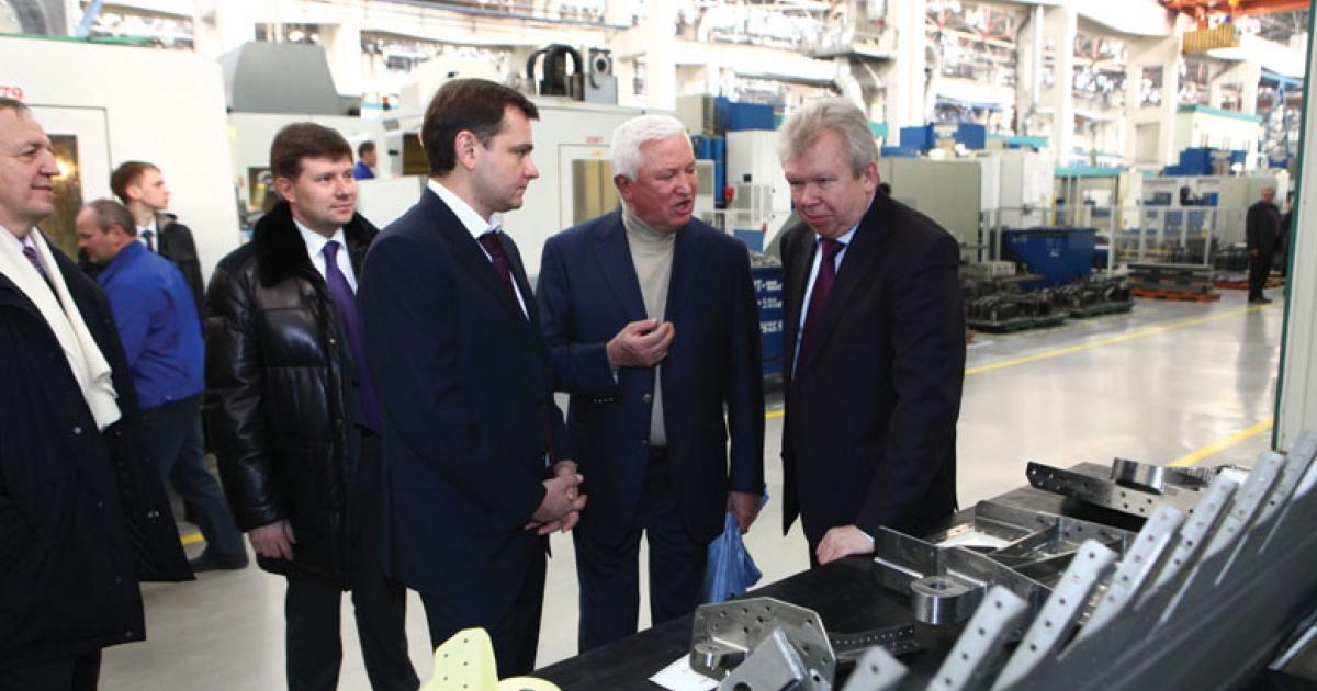 Irkut Corporation president Oleg Demchenko (center) briefs Russia’s deputy minister of industry and trade Yuri Slyusar (left) and the ministry’s aviation industry director Andrey Boginsky (right) on preparations for starting serial production of the MC-21 airliner at the Irkutsk Aviation Plant.