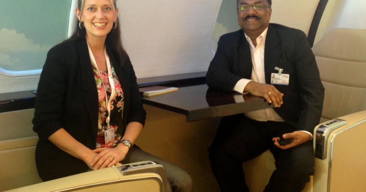 Rachel Bahr, EMTEQ’s chief marketing officer, and Dr. Praveen Srivastava, AVP-Aircraft Appearance Division for Air Works, sit in the Air Work's chalet lit with Emteq's Quasar Mood Lighting at India Aviation.