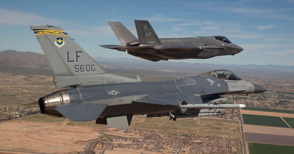 An F-16C from the 56th Fighter Wing escorts the first F-35A for the unit as it arrives at Luke AFB. (Photo: U.S. Air Force) 
