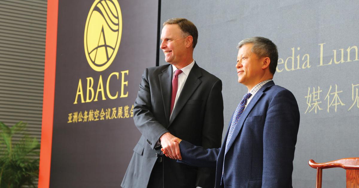 NBAA president and CEO Ed Bolen, left, announced an agreement with Li Derun, president of the Shanghai Airport Authority to “double down” on a contract to keep the ABACE show right here.hanghai’s 