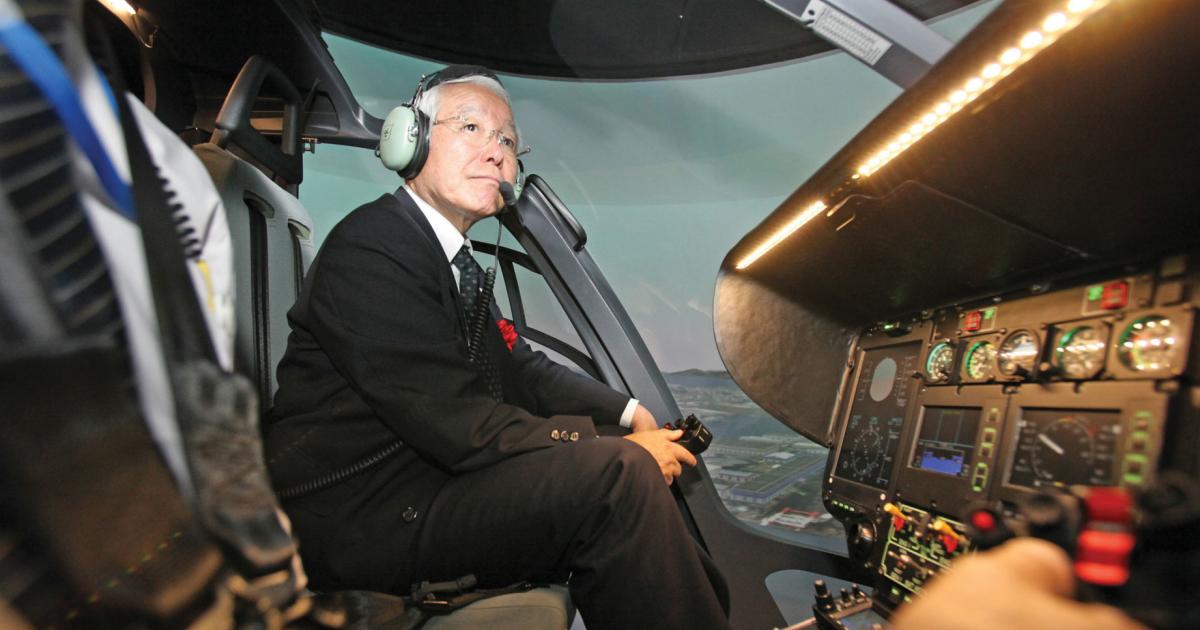 Toshizo Ido, the Governor of Hyogo Prefecture, examines the features of Airbus Helicopters’ new full flight simulator near Kobe Airport.