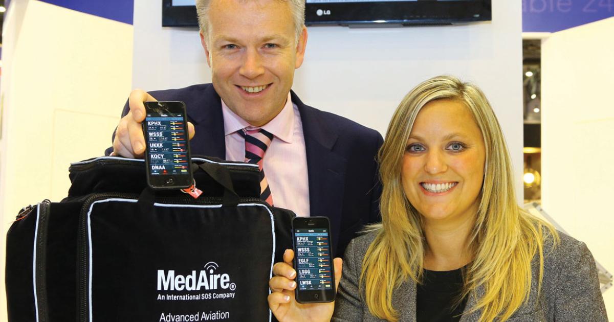 MedAire managing director Peter Tuggey, left, and product marketing manager Mandy Eddington demonstrate the company’s latest kits and its Trip Ready mobile app.