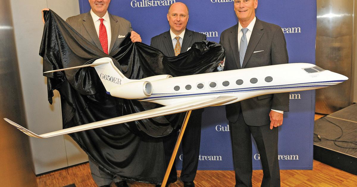 Gulfstream’s Mark Burns, president of product support; Scott Neal, vice president of worldwide sales and marketing; and president  Larry Flynn officially unveil the G650ER yesterday at EBACE. (Photo: Mark Wagner)