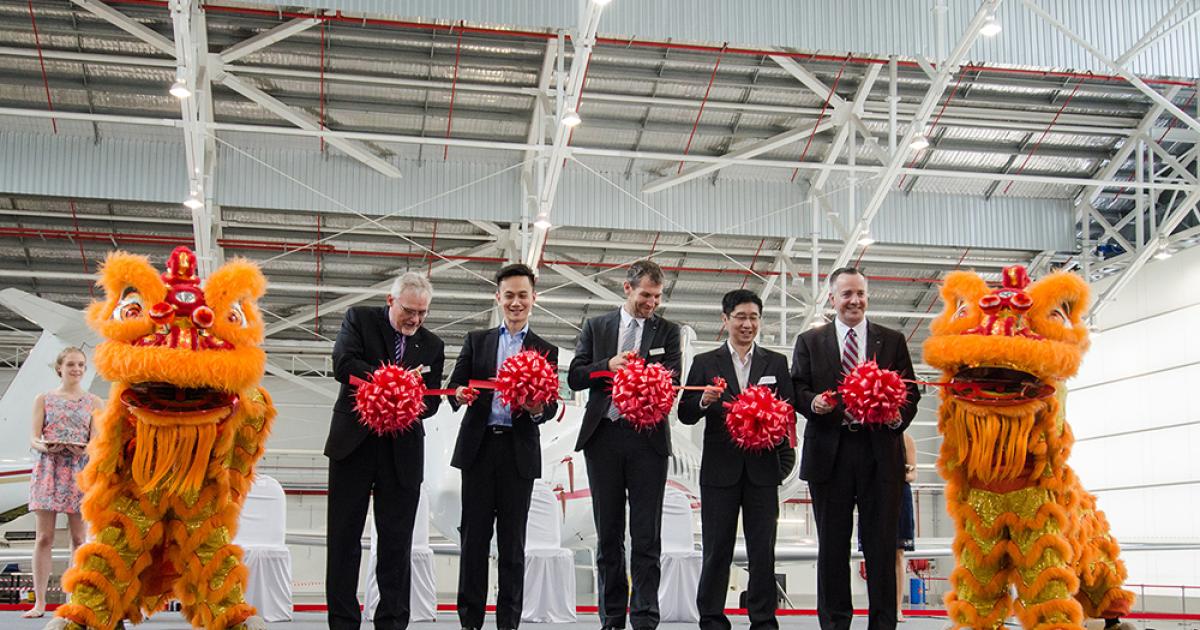 Executives from Jet Aviation open the doors to the company’s new hangar at Seletar Aerospace Park.