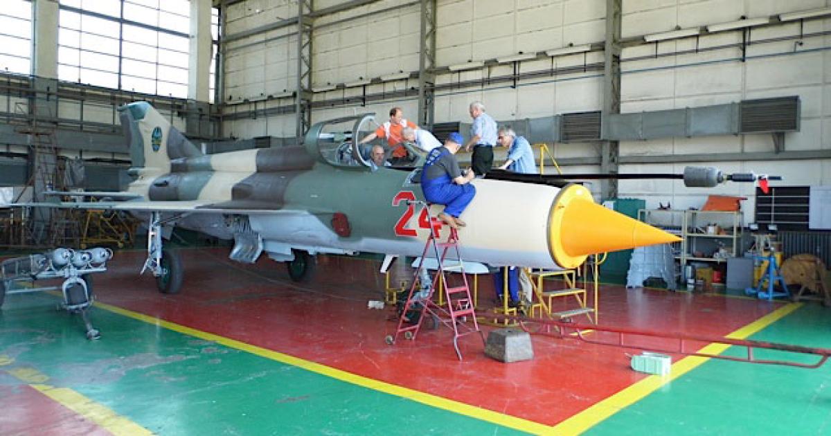 Workers at the Aerostar facility in Bacau, Romania, complete their work to overhaul one of eight MiG-21s for the Mozambique air force. (Photo: Ian Sheppard)