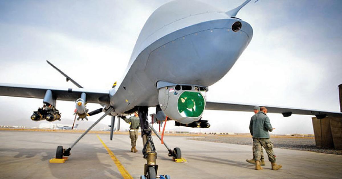 The Reaper can be armed with four Hellfire missiles and two GBU-12 laser-guided 250-pound bombs. The RAF usually flies with all four missiles, but only one bomb. The UAV’s Raytheon MTS-B sensor ball and laser rangefinder/designator is beneath the nose, with the satcom antenna above.