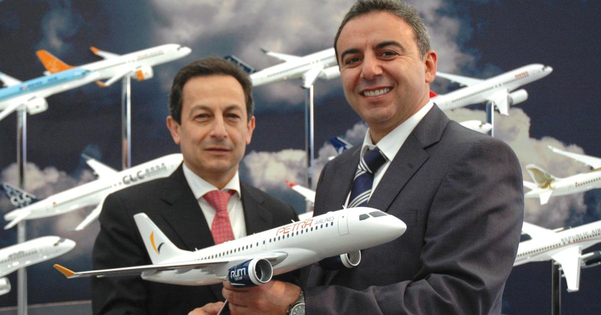 Mike Arcamone, left, Bombardier president of commercial aircraft, congratulates Riad Khashman, CEO of Jordan-based Petra Airlines on a new letter of intent for up to four CSeries airliners. The 
deal is valued at $298.4 million.