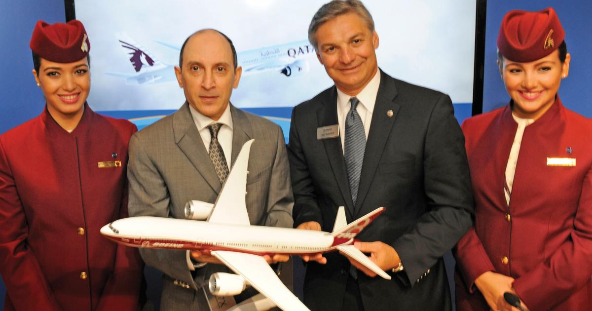 Flanked by Qatar Airways flight attendants, airline CEO Akbar Al Baker, left, has endorsed Boeing’s 777-9X program, to the pleasure of Boeing CEO Ray Conner.