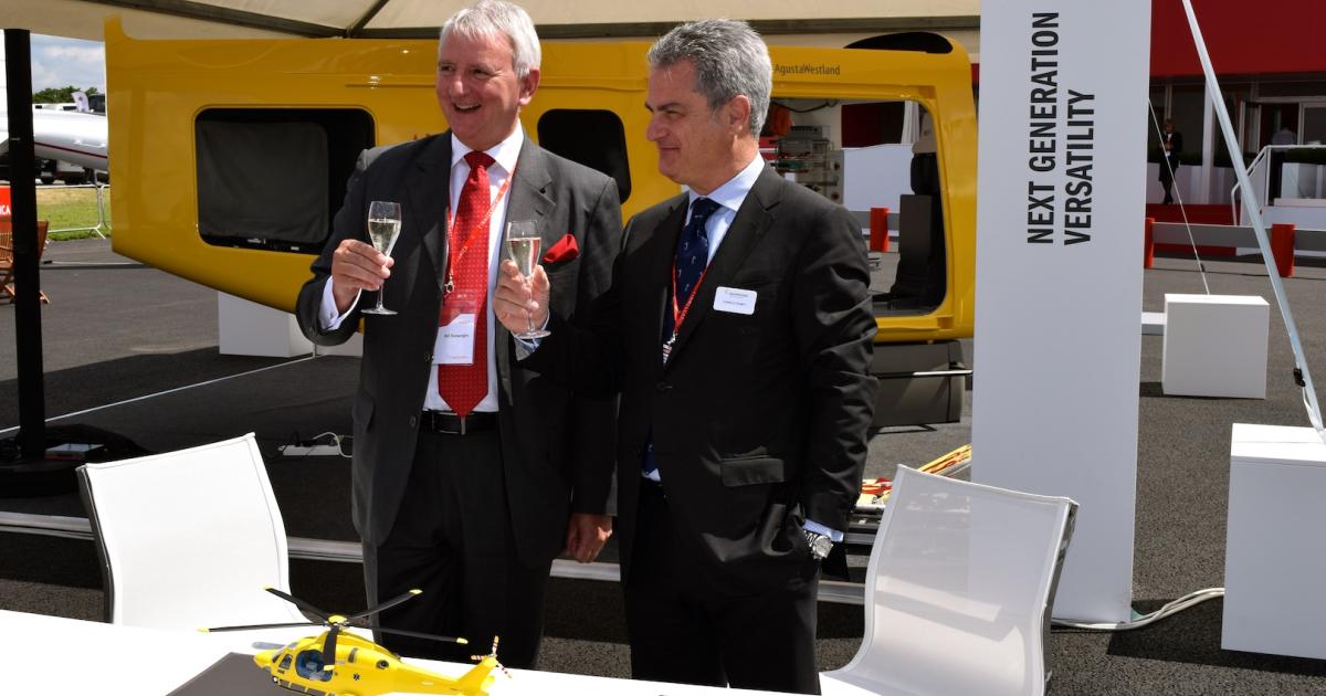  Bill Sivewright, Dorset and Somerset Air Ambulance CEO, l, and AgustaWestland CEO Daniele Romiti toast AW169 order signing at Farnborough Airshow. (Photo: Bill Carey)