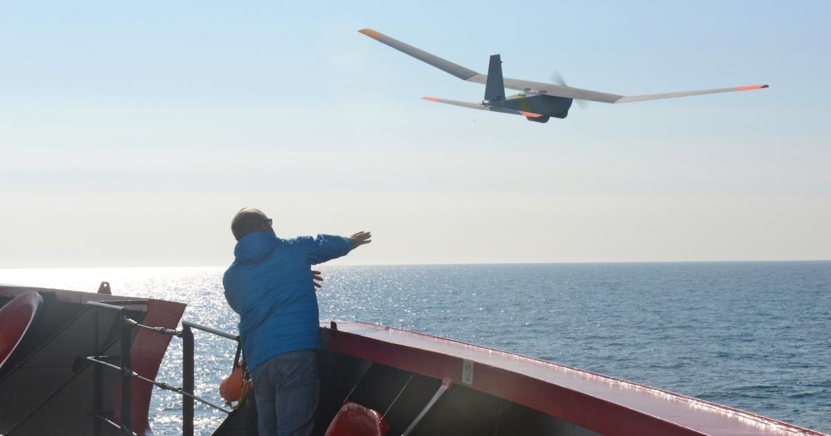 AeroVironment's John Ferguson launches a Puma AE from the icebreaker Healy during an exercise in the Arctic Ocean. (Photo: U.S. Coast Guard)