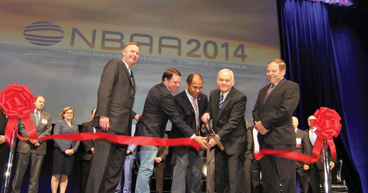 Clipping the ribbon at this year’s NBAA show are (l to r) NBAA president and CEO Ed Bolen; Sen. Sam Graves (R-Mo.); acting NTSB chairman Chris Hart; Enterprise Holdings executive chairman Andrew Taylor (featured speaker); and Lynn Krogh, CEO of International Jet Aviation, supporter of the Make-A-Wish Foundation.