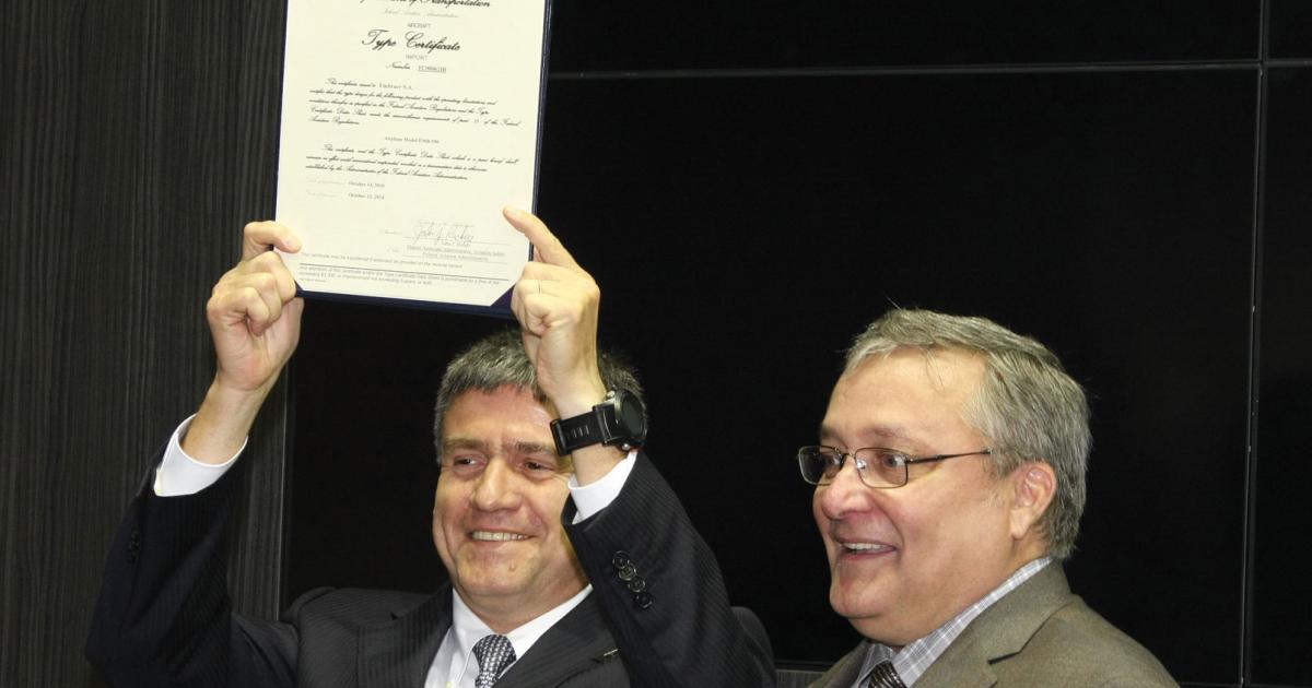 Embraer Executive Jets president Marco Túlio Pellegrini displays the FAA type certificate for his company’s Legacy 500. The paperwork was freshly signed by FAA deputy associate administrator John Hickey.