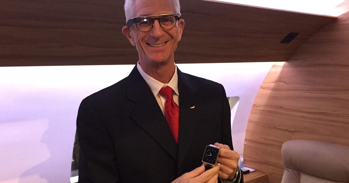 William Rowell, Honeywell’s business and general aviation senior manager for technical sales, shows off the Google Glass and Samsung smart watch wearable devices that can control the Ovation Select cabin management system in a mockup at NBAA 2014.