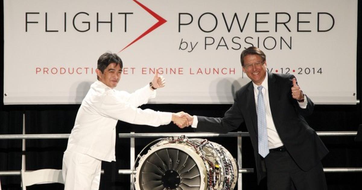 Honda Aero president and CEO Masahiko Izumi and North Carolina Governor Pat McCrory (R) show off the first production GE Honda HF120 engine built by workers at Honda Aero’s Burlington, N.C. headquarters. The ceremony on November 12 marked the official launch of operations at the plant. (Photo: Paul Vernon) 