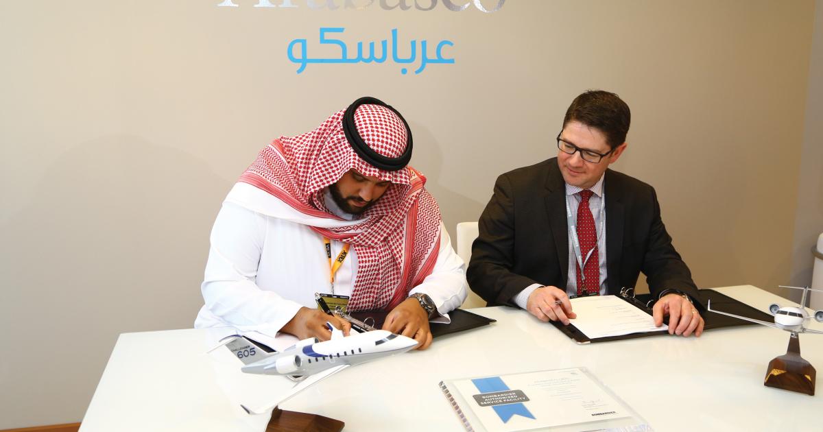 HRH Prince Abdullah Bin Turki Al Saud, Arabasco chairman, left, signs an agreement authorizing the company as a service center for the Challenger 605. Eric Martel, president Bombardier Business Aircraft looks on.