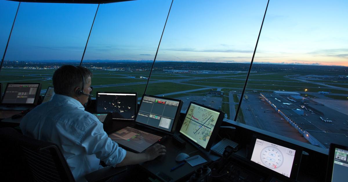 A Nav Canada controller is shown at work in the tower at Calgary International Airport. (Photo: Nav Canada)
