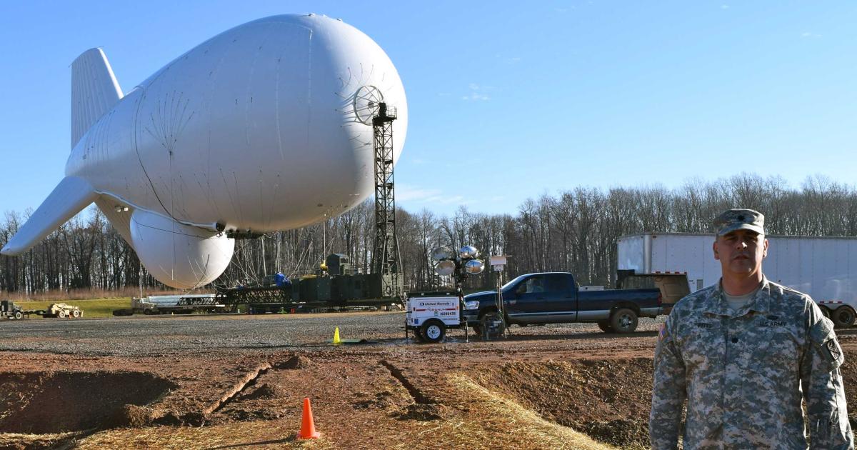 Lt. Col. William Pitts stands in front of the JLens aerostat at Aberdeen Proving Ground. (Photo: Bill Carey)

