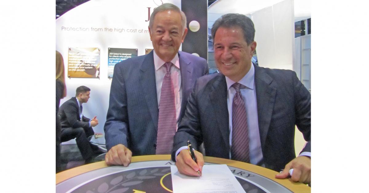  JSSI vice chairman Bryan Moss, left, signs agreement with Tarek Ragheb, founding chairman of AfBAA.