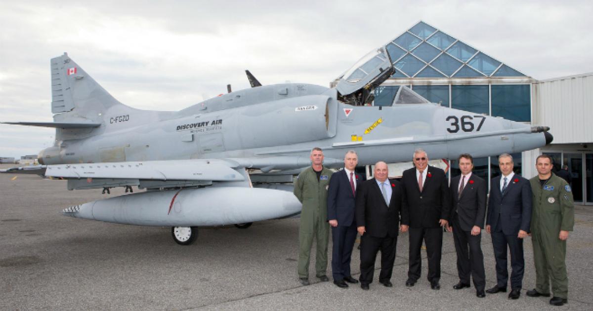 Company and local officials gathered in front of one of the seven A-4N Skyhawks that Discovery Air Services is sending to Germany for its new contract there. (photo: Discovery Air)
