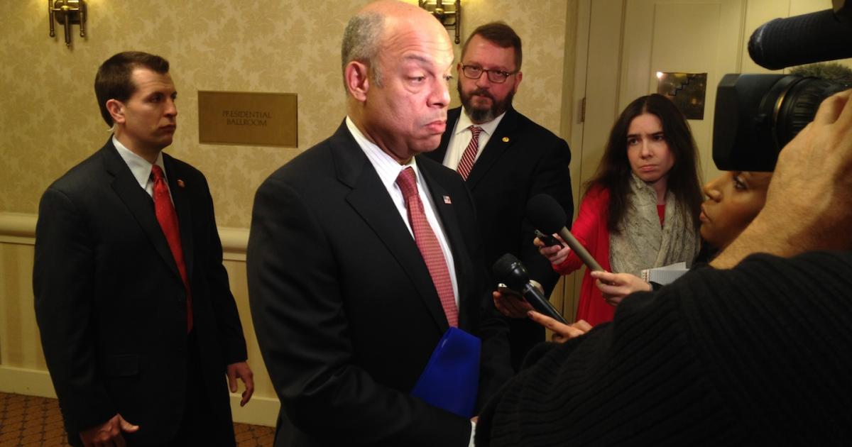 Homeland Security Secretary Jeh Johnson is surrounded by reporters after speaking to the Aero Club of Washington. (Photo: Bill Carey)
