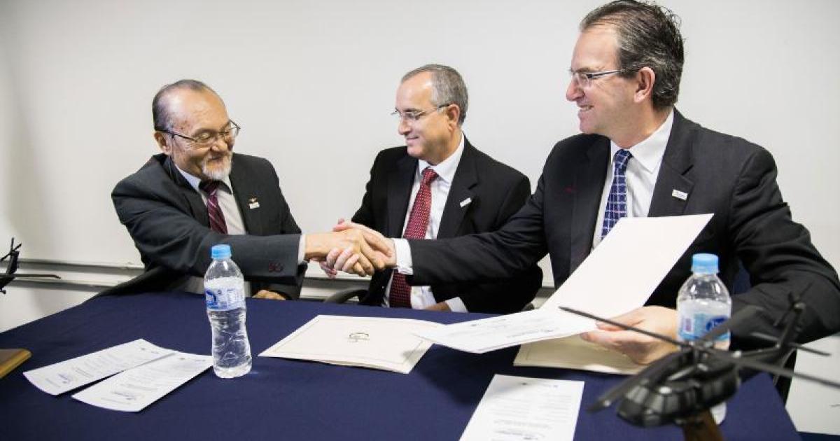 Sikorsky Vice President Chris Van Buiten (right) and ITA Vice Dean Fernando Sakane shake hands to seal the new collaboration with ITA. Antonio Pugas, Sikorsky Regional Sale Executive for Latin America looks on. (PRNewsFoto/Sikorsky Aircraft Corp.)