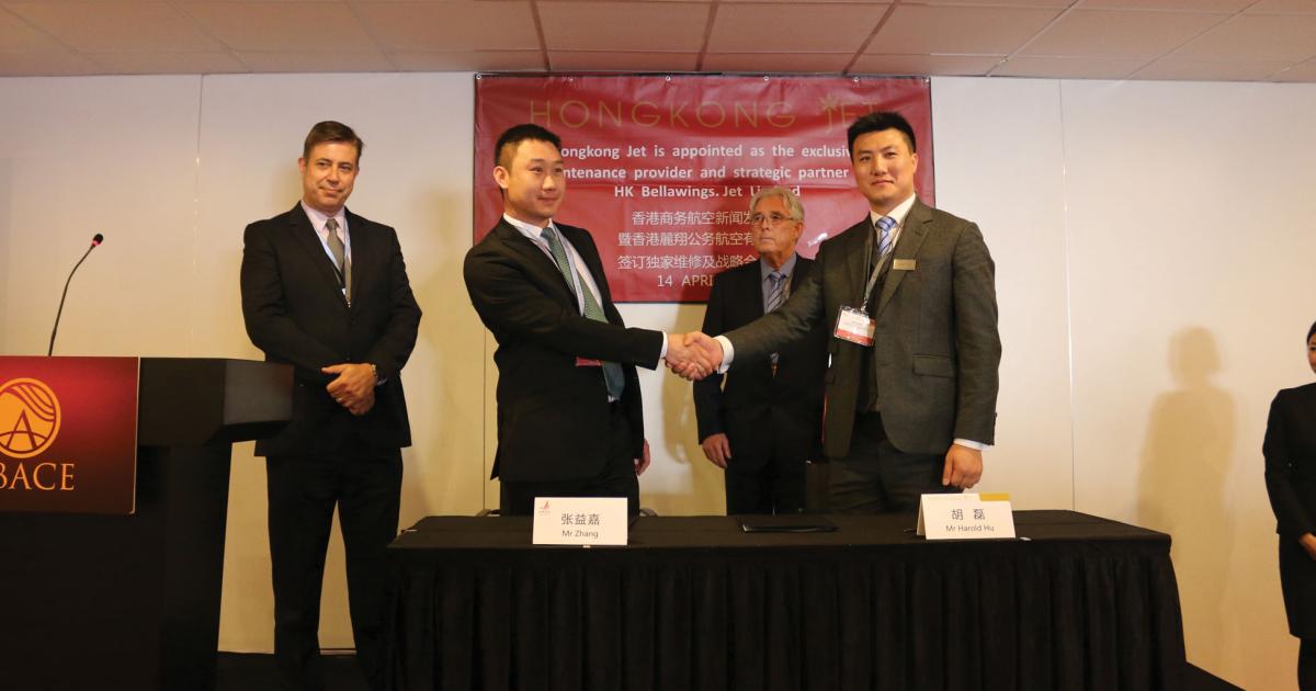 Bellawings executive v-p Zhang Yijia, left, shakes hands on a maintenance deal with  Hong Kong Jet director of business development Harold Wu, as Hong Kong Jet COO Denzil White looks on. The deal will support Bellawings’ growing jet fleet.