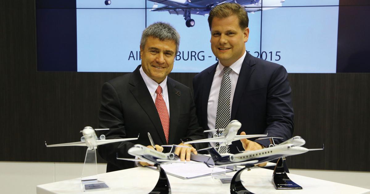 Germany-based charter operator Air Hamburg signed with Embraer Executive Jets president and CEO Marco Tulio Pellegrini, left, for a new Embraer Legacy 650. (Photo: David McIntosh)