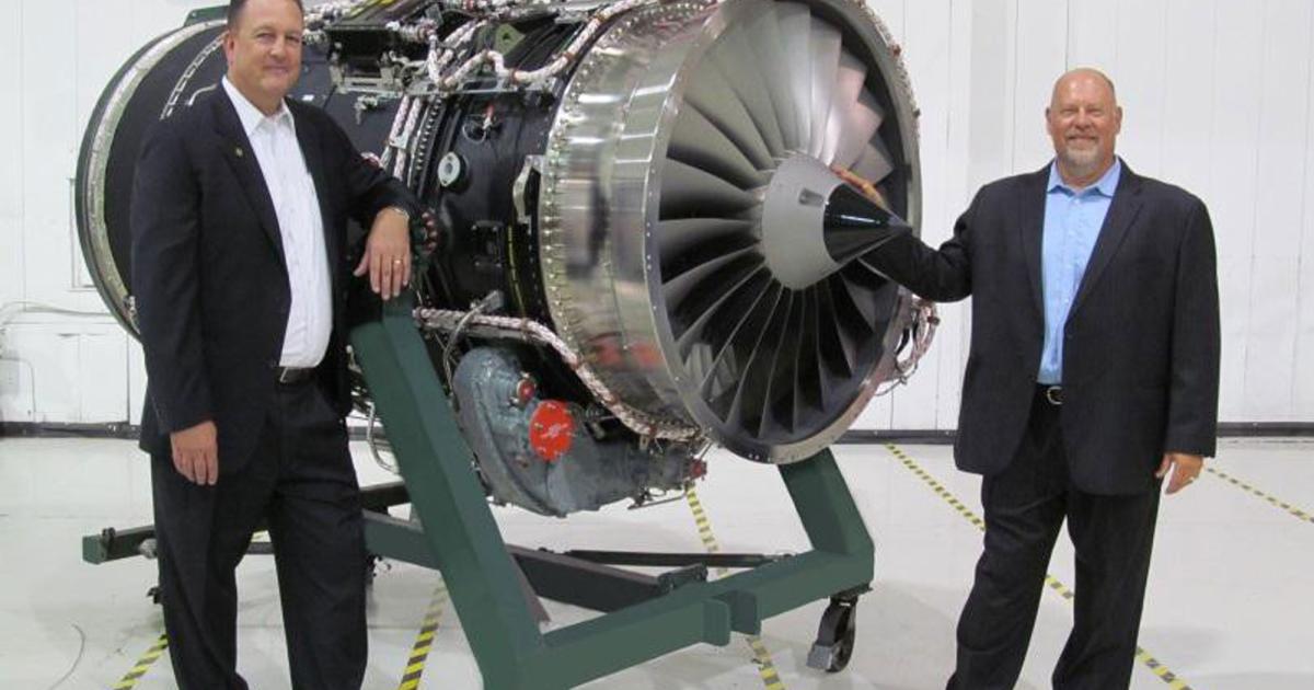 Bizjet International vice president of engine services Criss Berry (l) and vice president of sales and marketing Brian Barber stand next to the company's new Tay Mk 611-8C lease engine. (Photo: Bizjet International)