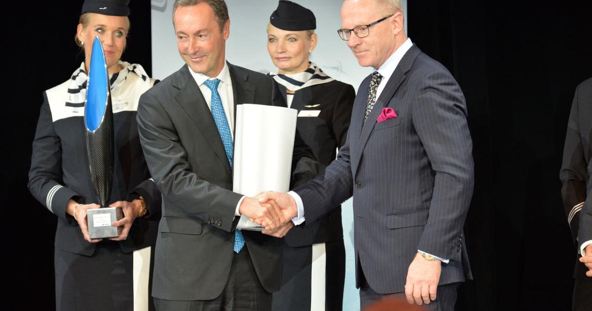 Airbus CEO Fabrice Bregier (left) congratulates Finnair CEO Pekka Vauramo upon delivery of the first Finnair A350. (Photo: Airbus)