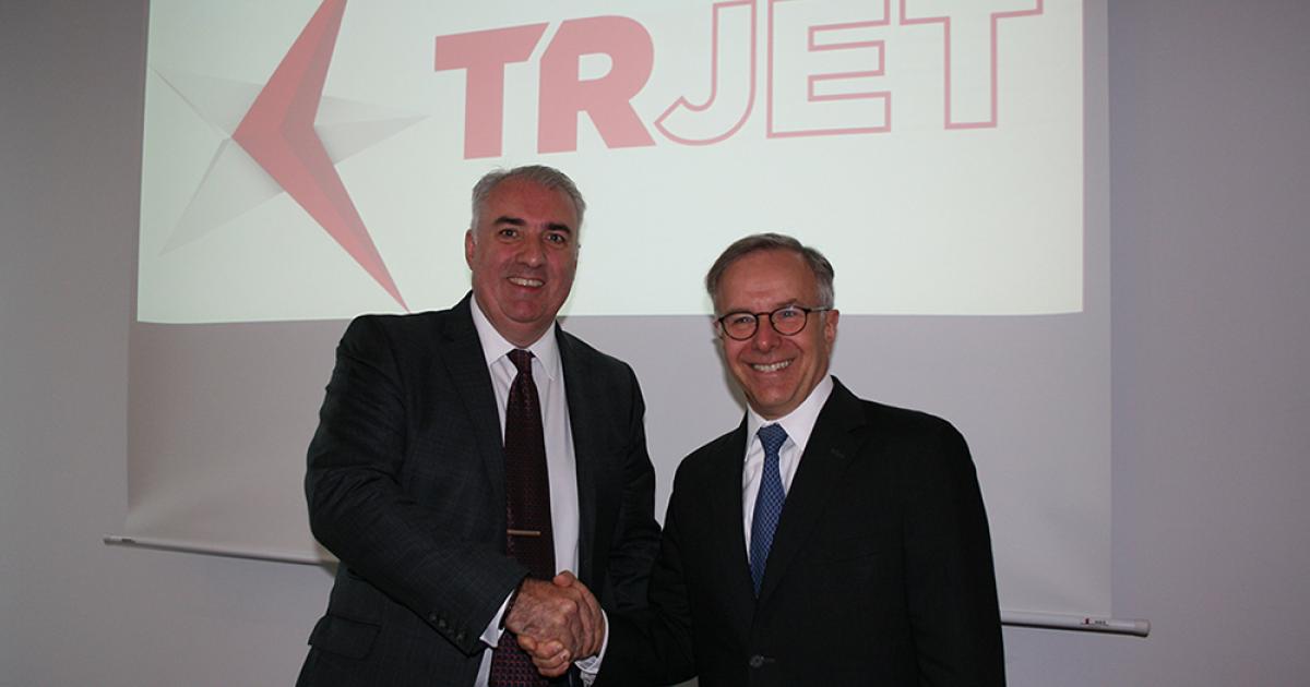 Dave Jackson, managing director of 328 Support Services and Richard Dussault, Pratt & Whitney Canada v-p of marketing, celebrate on an MoU to collaborate on the new T328 program in Berlin.