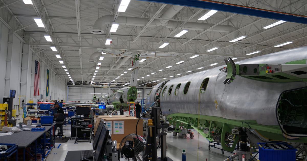To make room for Legacy 450/500 assembly at its executive jet production facility in Melbourne, Fla., Embraer is removing an outside wall, shown here to the left of the current Phenom 100/300 production line, to expand outward while still permitting aircraft to be built during construction. When AIN visited in mid-October, the outside wall was being prepared for removal. (Photo: Chad Trautvetter/AIN)