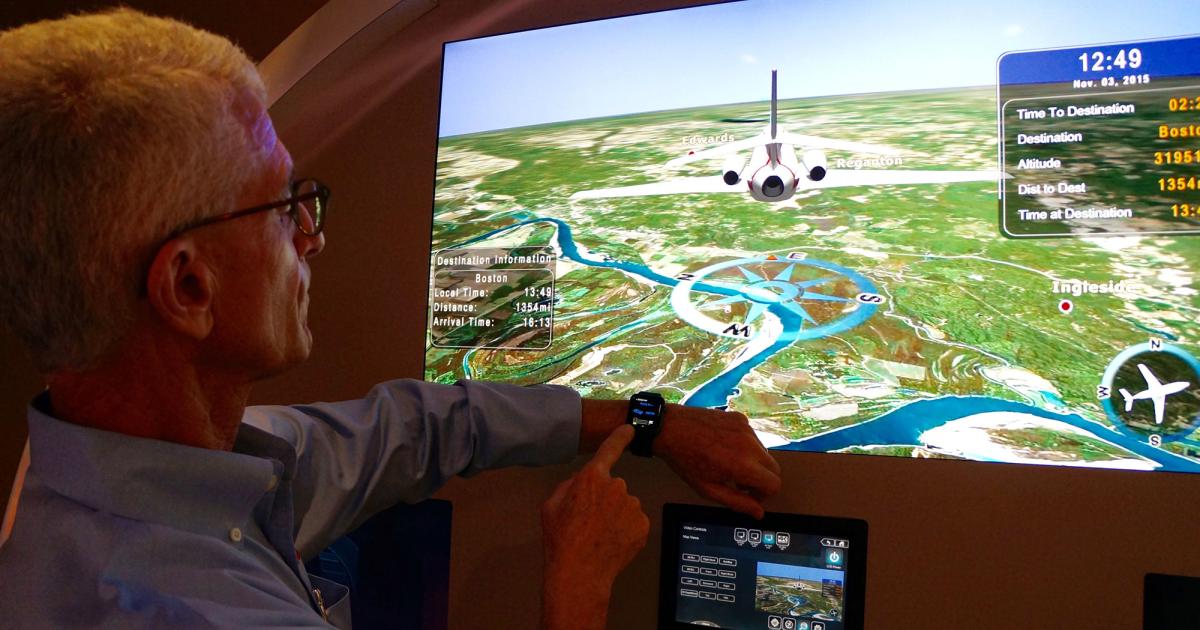 William Rowell, Honeywell senior manager for business and general aviation cabin systems technical sales, demonstrates a development version of an Apple Watch app that can control cabin systems at the company's cabin management development facility in Sarasota, Fla. Because it works on a wearable device, the Ovation Select cabin management systems app can notify the flight attendant that one of the passengers pushed the attendant call button, while passengers can be notified when the seat-belt sign is turned on or off. It can also be used to control cabin lighting, monitor displays, temperature, flight map information and electronic shades. (Photo: Chad Trautvetter/AIN)