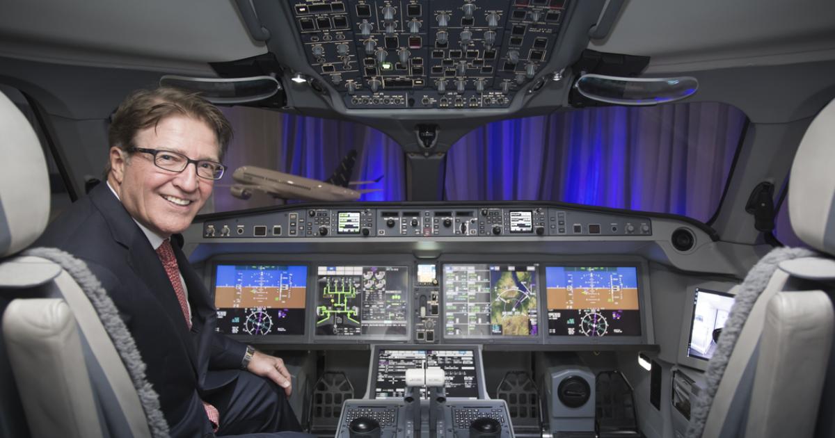 Porter Airlines CEO Robert Deluce sits in a CSeries mockup following his signature of a conditional purchase agreement covering 12 of the jets in 2013. 